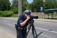 policjant patrzy przez zestaw fotograficzny